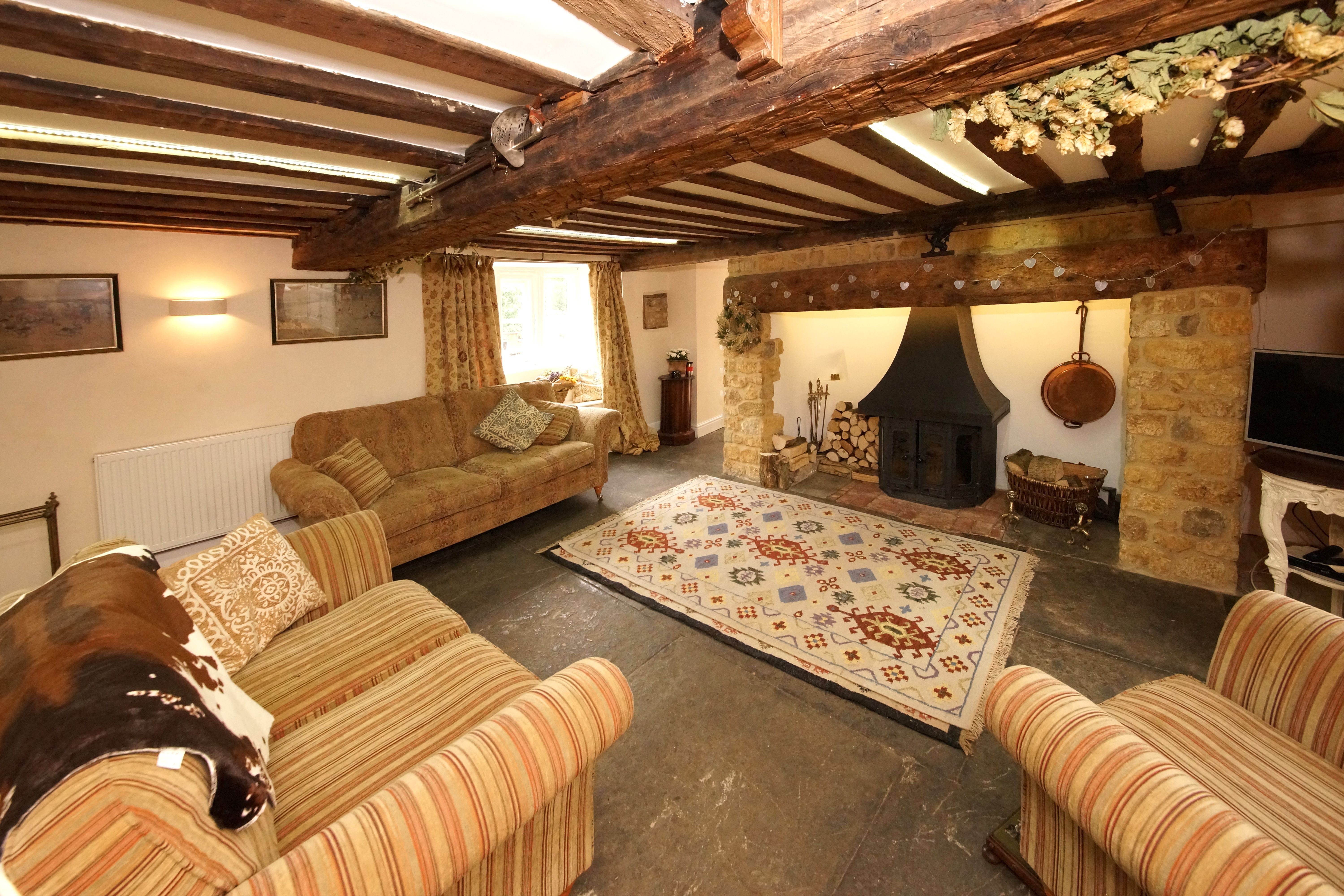 Cozy Rustic Living Room with Fireplace and Beams · Free Stock Photo