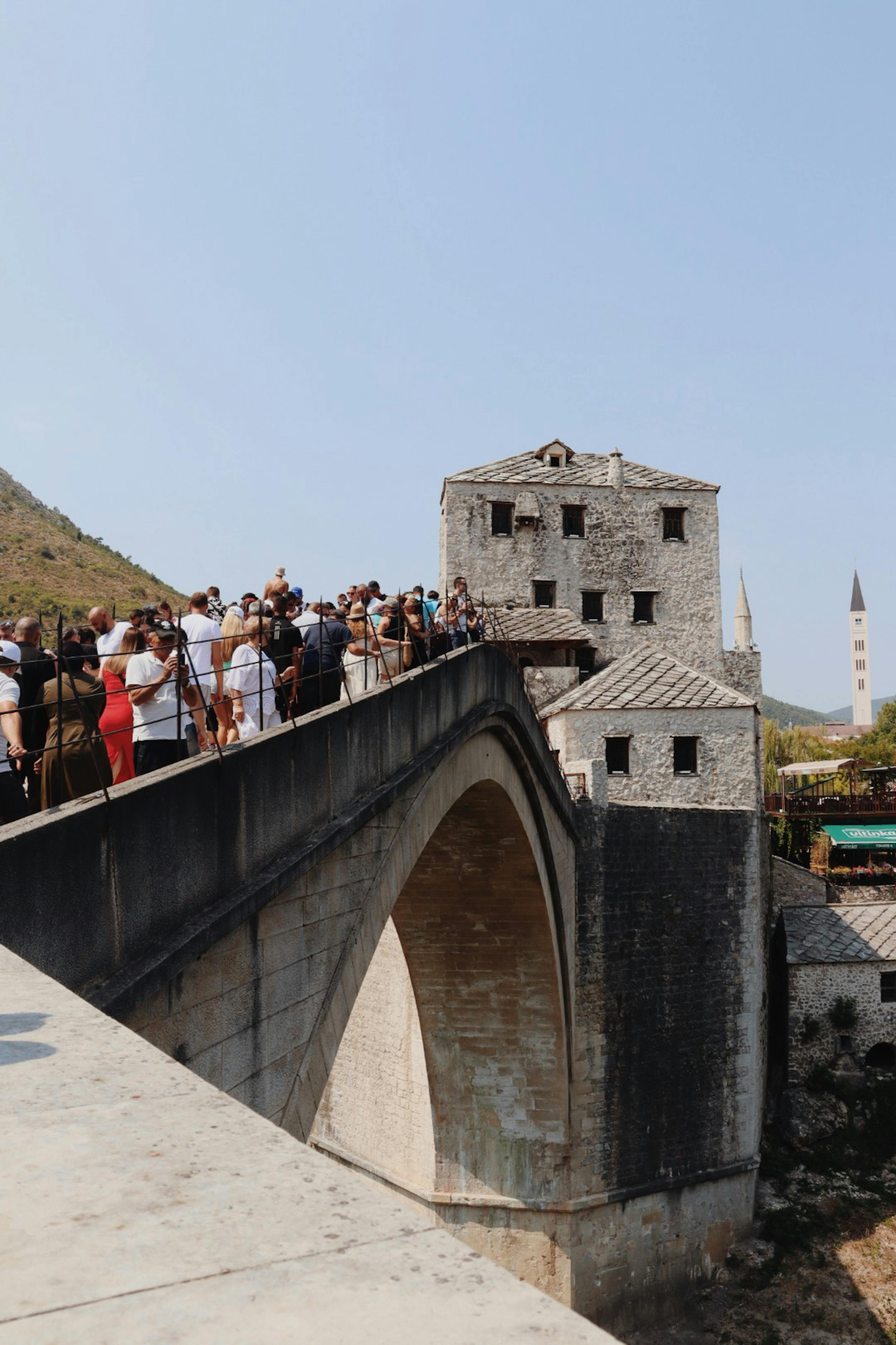 Visitors enjoy the view from the iconic Stari Most bridge in Mostar, Bosnia and Herzegovina.