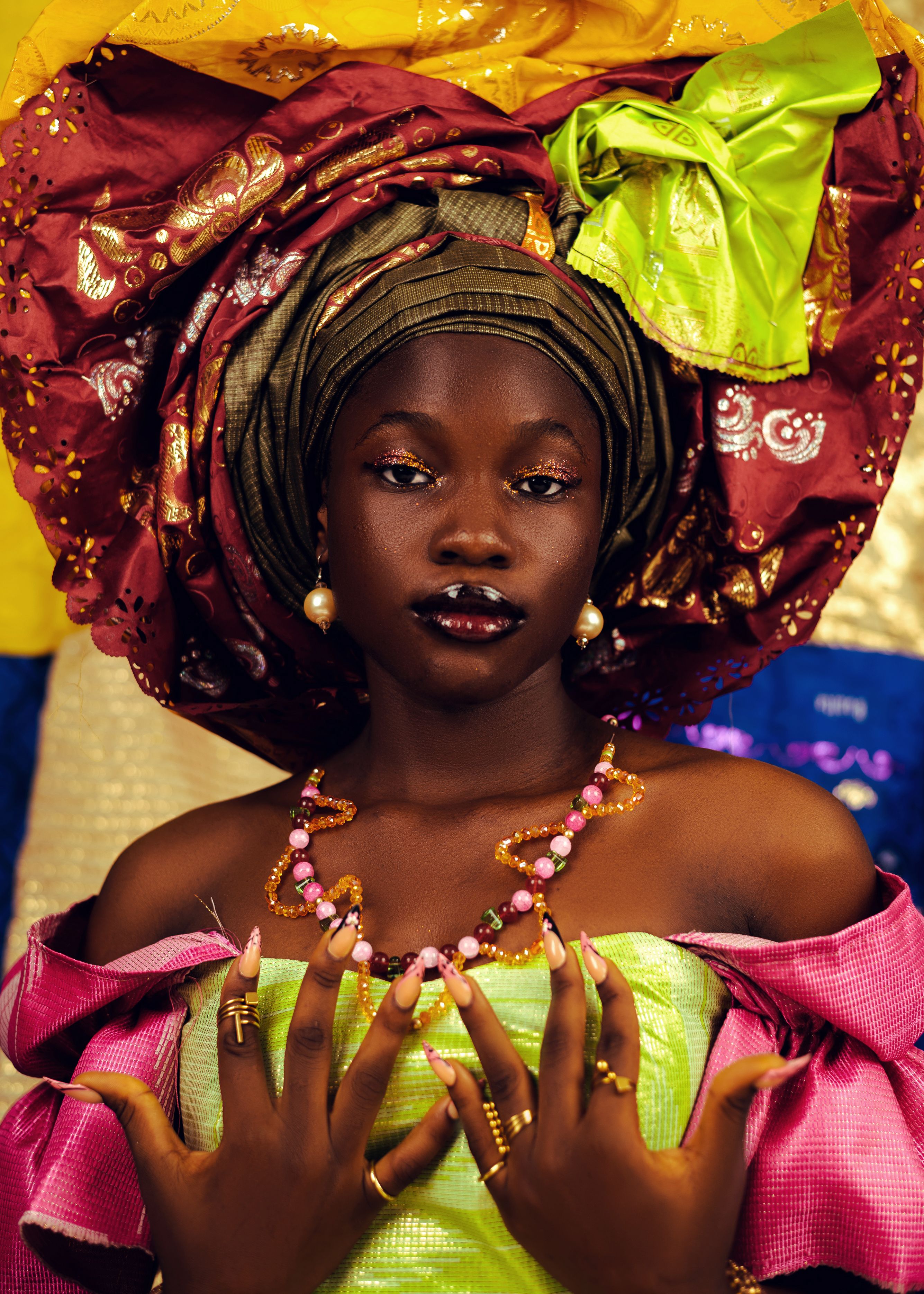 A vibrant portrait of a woman in traditional African attire with detailed accessories.