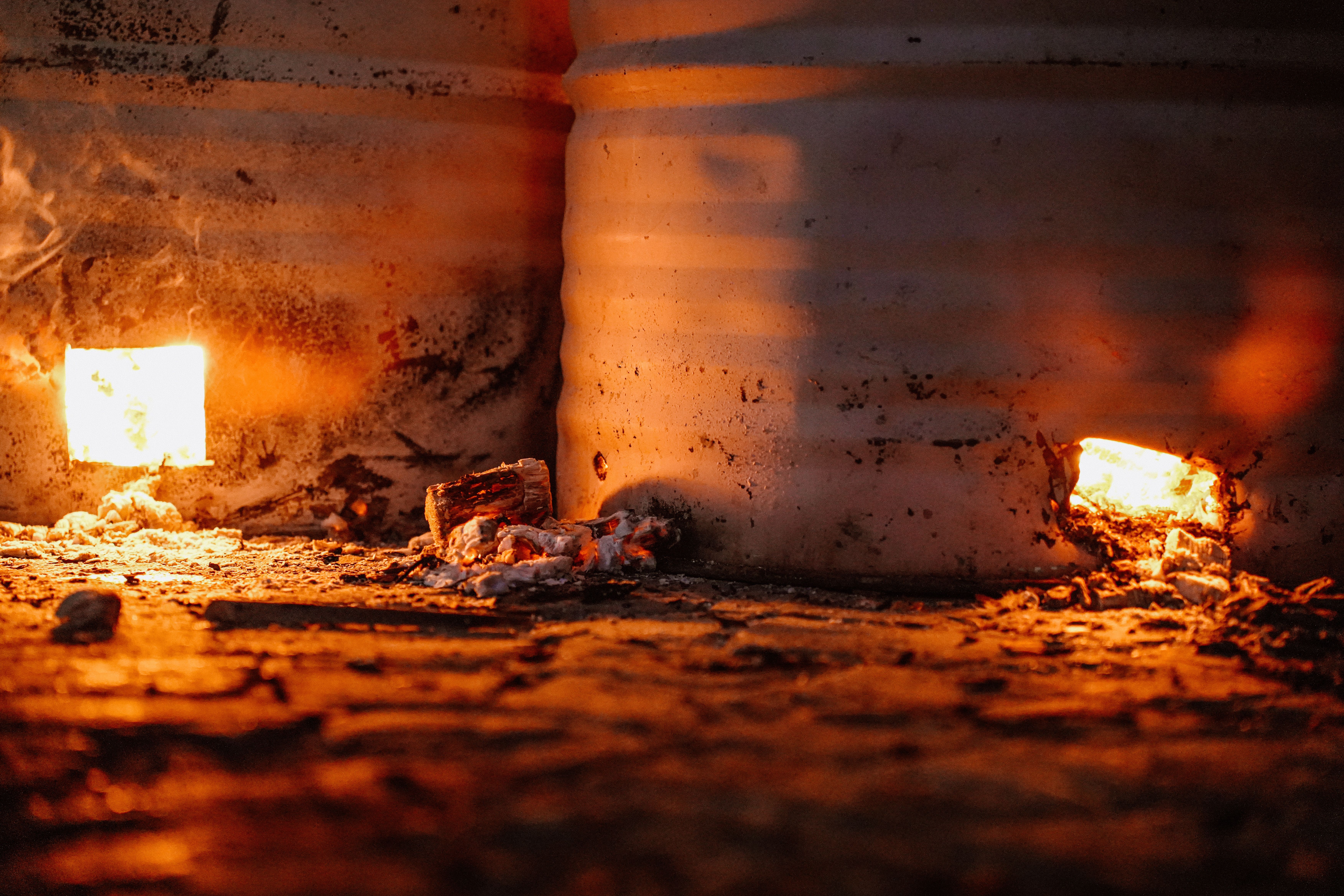 Close-up of a warm furnace fire in a rustic, industrial setting.