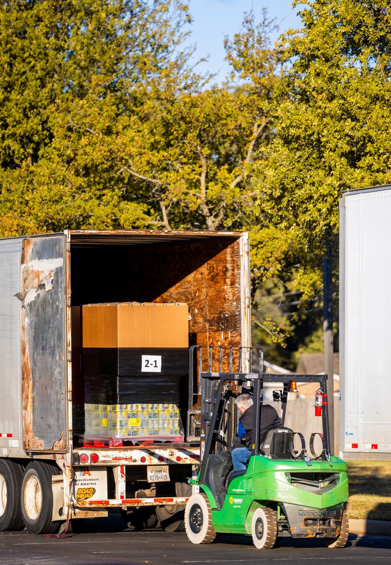 Forklift loading a pallet onto a freight truck