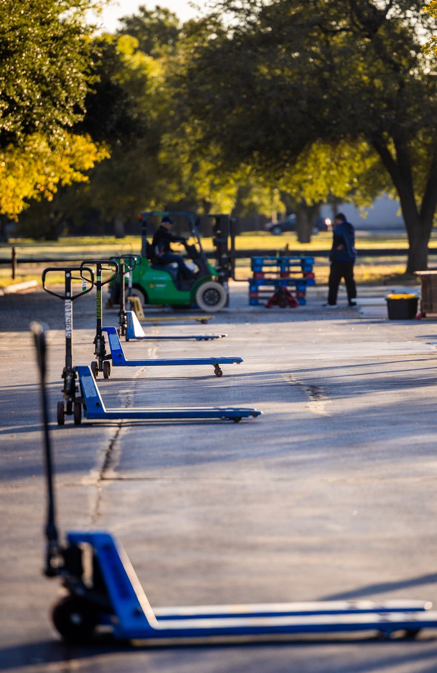 Forklift and pallet jacks at an industrial site
