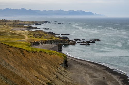 Free Dramatic coastal view featuring rocky cliffs and a serene ocean, perfect for nature enthusiasts. Stock Photo