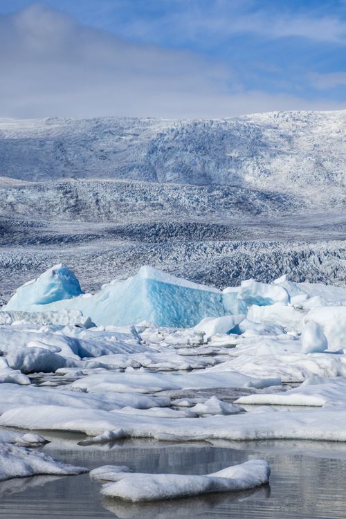 Free Glacial icebergs floating in a serene Arctic landscape under clear skies. Stock Photo