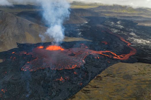 Stunning aerial shot of an active volcano eruption in Iceland with glowing lava.