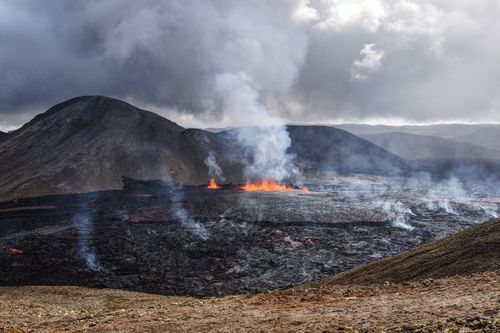 Free Captivating image of an active volcanic eruption with smoke and lava flow. Stock Photo