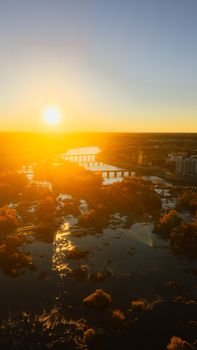Aerial view of Richmond, Virginia at sunset with James River reflecting golden light. Captivating scene.