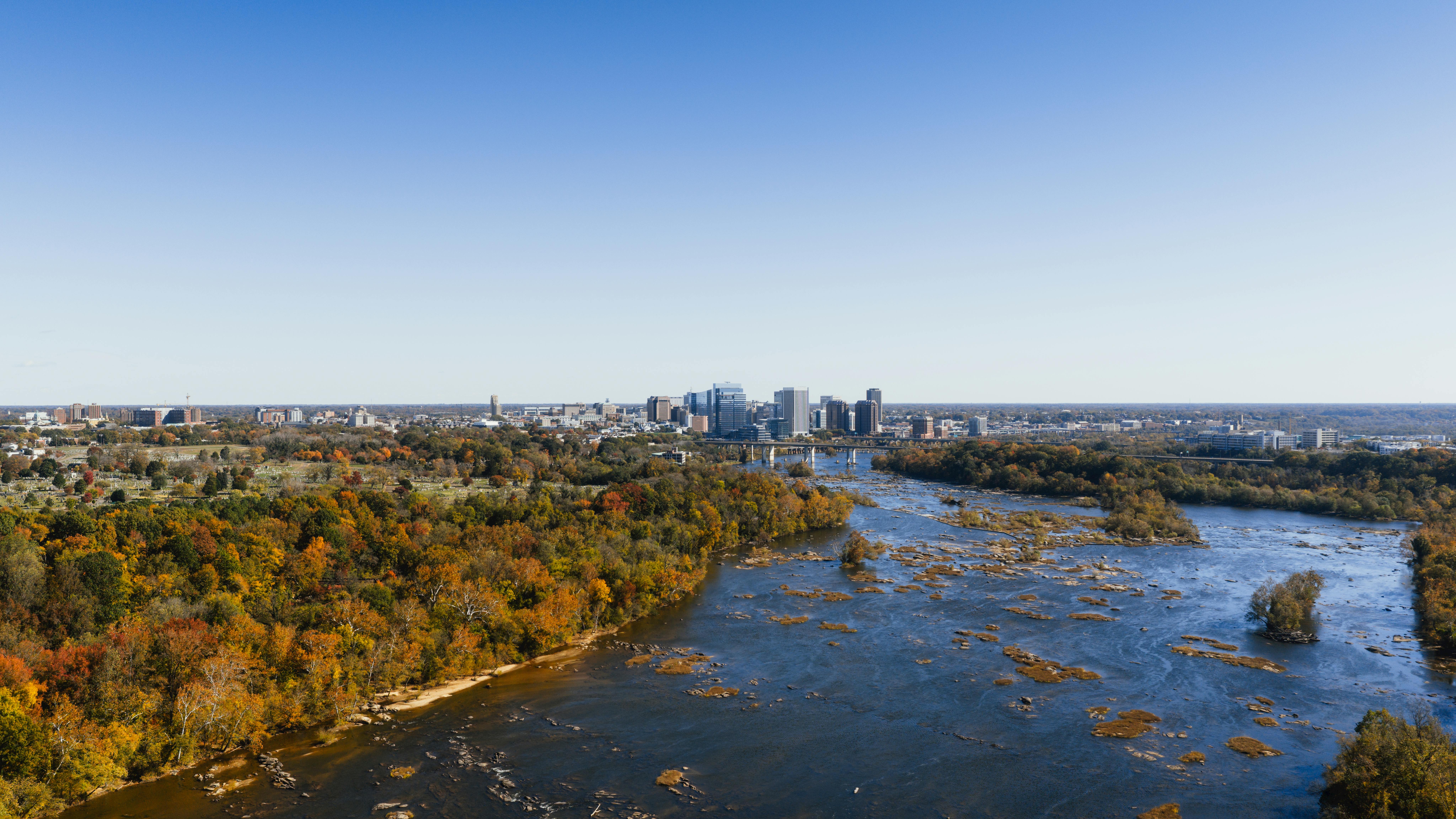 A stunning aerial view of the Richmond city skyline with fall foliage along the James River.