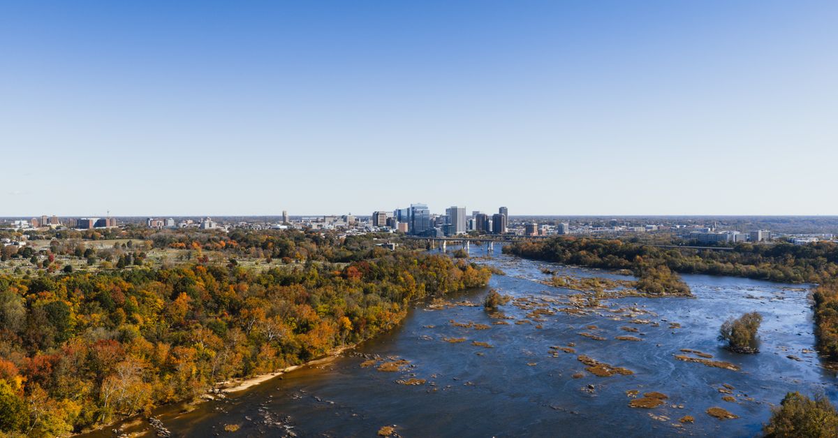 A stunning aerial view of the Richmond city skyline with fall foliage along the James River.
