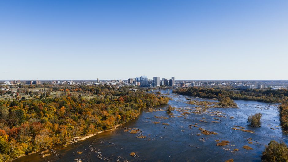 A stunning aerial view of the Richmond city skyline with fall foliage along the James River.