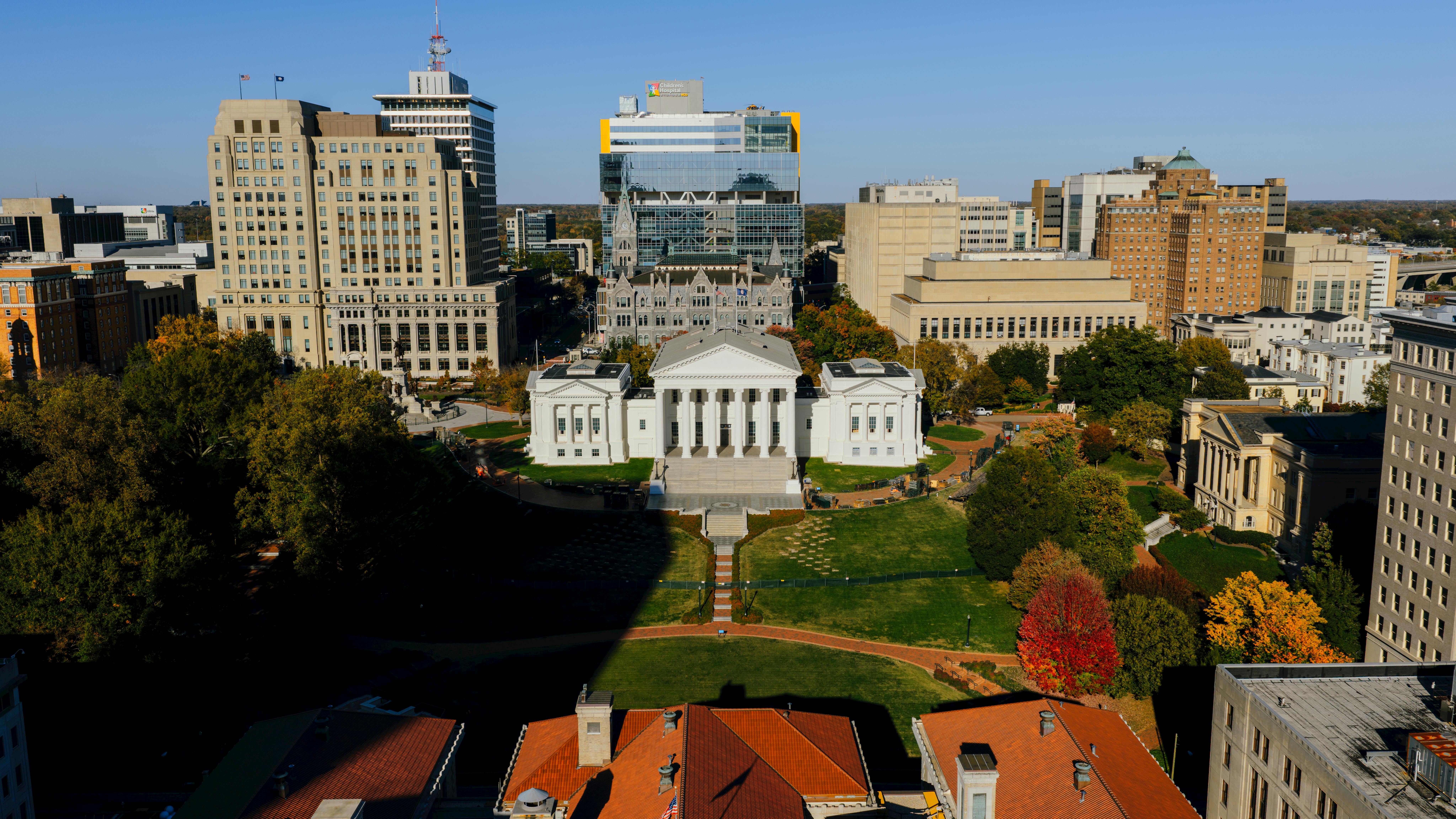 Aerial view of the Virginia State Capitol building surrounded by downtown Richmond, showcasing autumn colors.