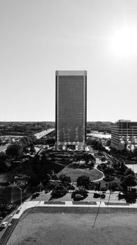 A striking black and white aerial view of the Richmond skyline with the sun shining brightly.