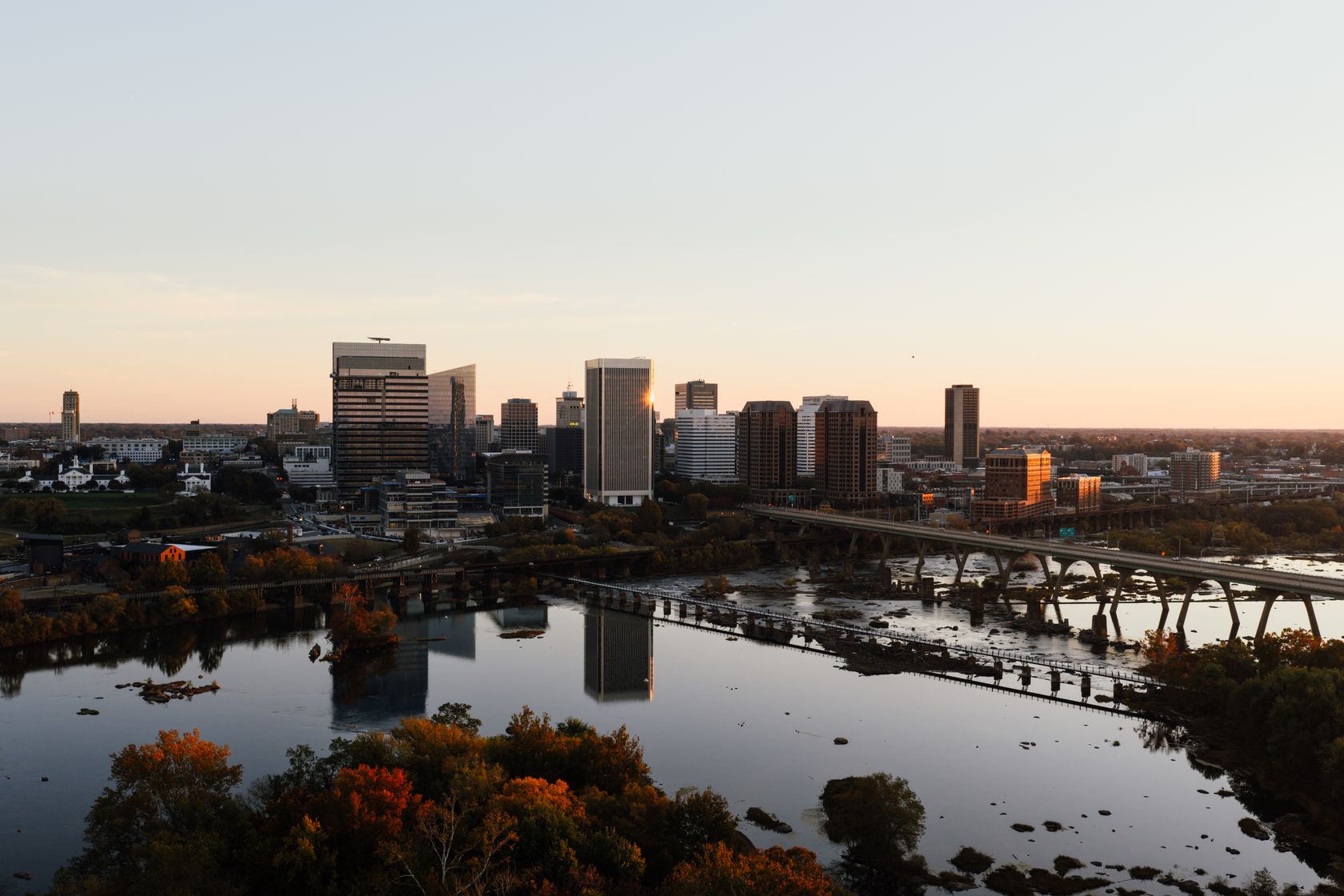 Aerial view of Richmond, Virginia skyline with James River at sunset.