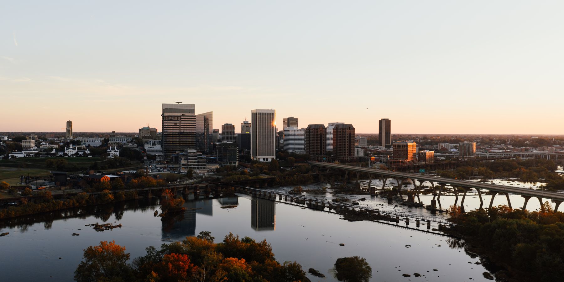 Aerial view of Richmond, Virginia skyline with James River at sunset.