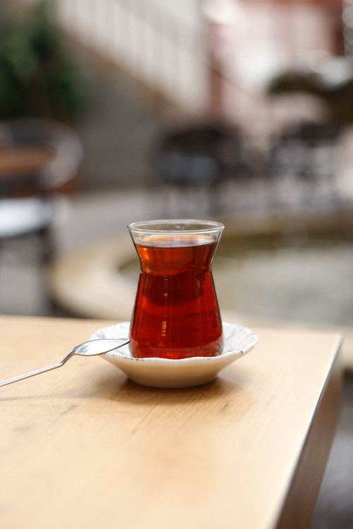 Free Beautifully served Turkish tea in a classic glass on a wooden table with soft focus background. Stock Photo