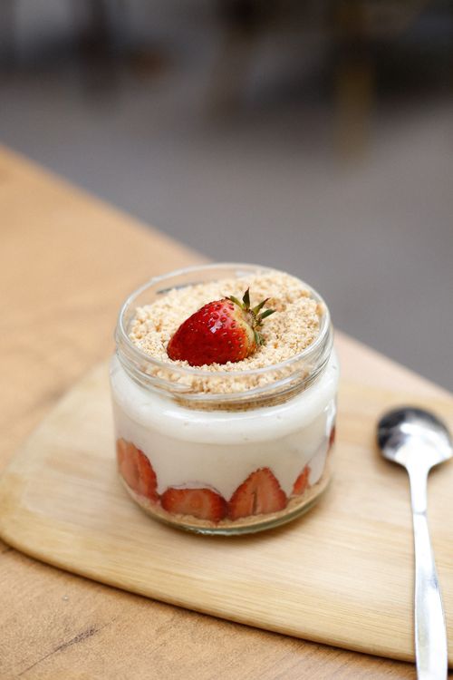 Free Tempting strawberry yogurt dessert in a jar with biscuit crumble, perfect for sweet cravings. Stock Photo