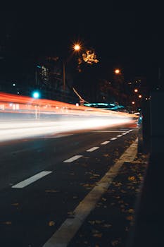 Long exposure of city traffic lights on a street in Frankfurt at night.