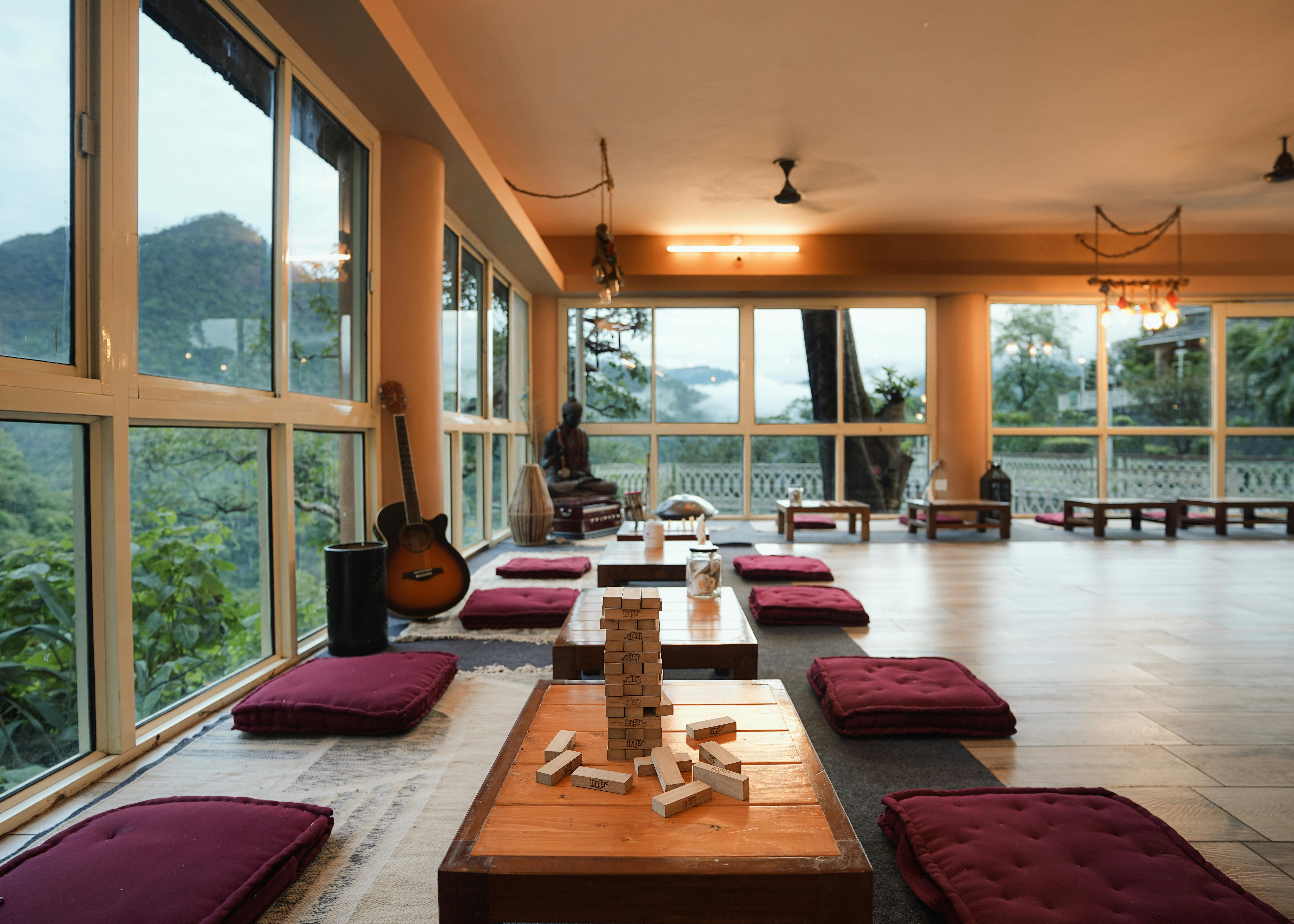 A tranquil meditation space in Rishikesh overlooking lush mountains, perfect for relaxation.