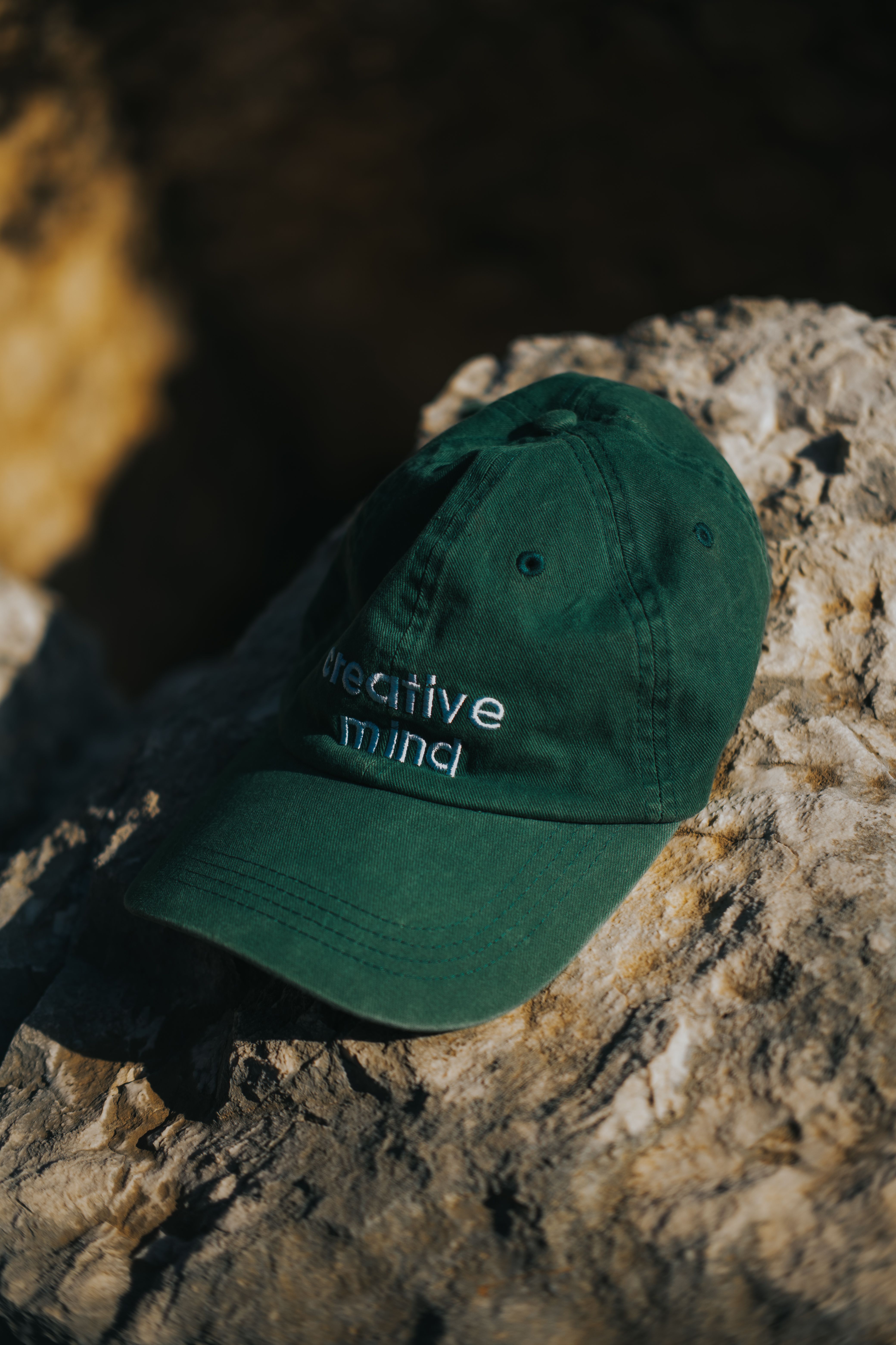 Green Cap on Rocks in Natural Light · Free Stock Photo