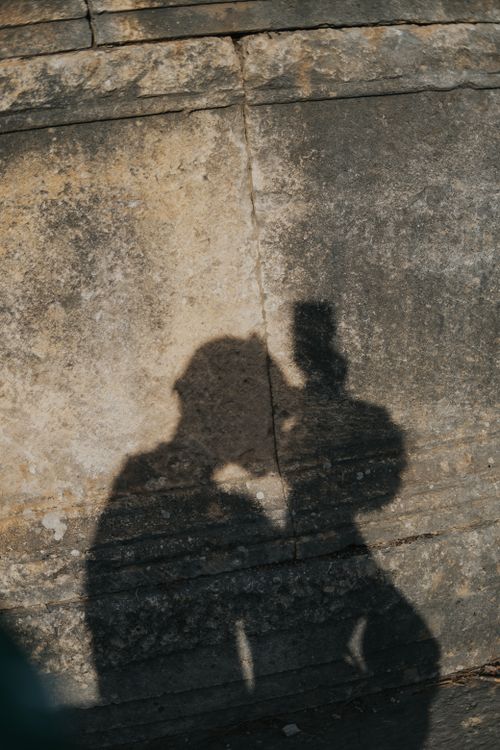 Free Shadows of two adults on a textured stone wall, creating an artistic abstract effect. Stock Photo