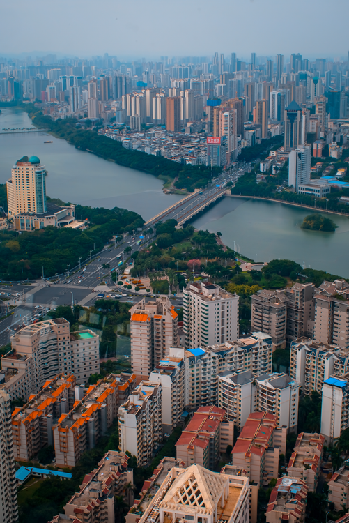 Aerial View of Modern Cityscape with River and Bridge · Free Stock Photo