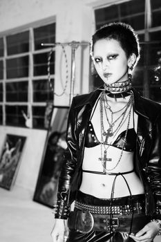 Striking black and white portrait of a woman in punk fashion attire.