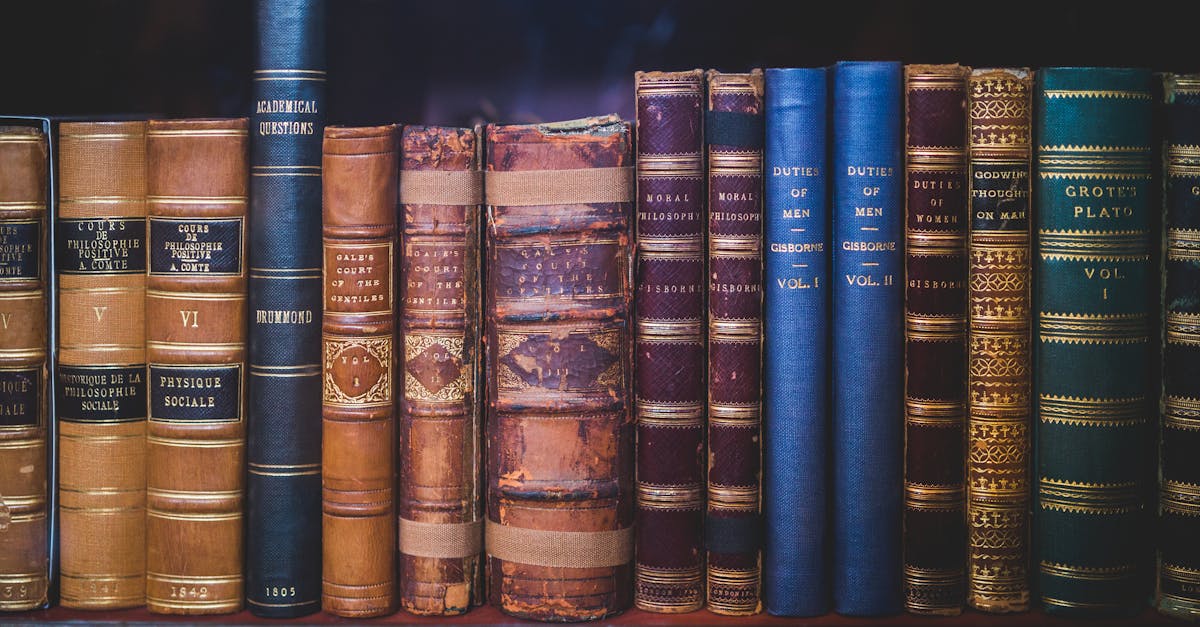 A collection of classic, leather-bound books neatly arranged on a wooden bookshelf.