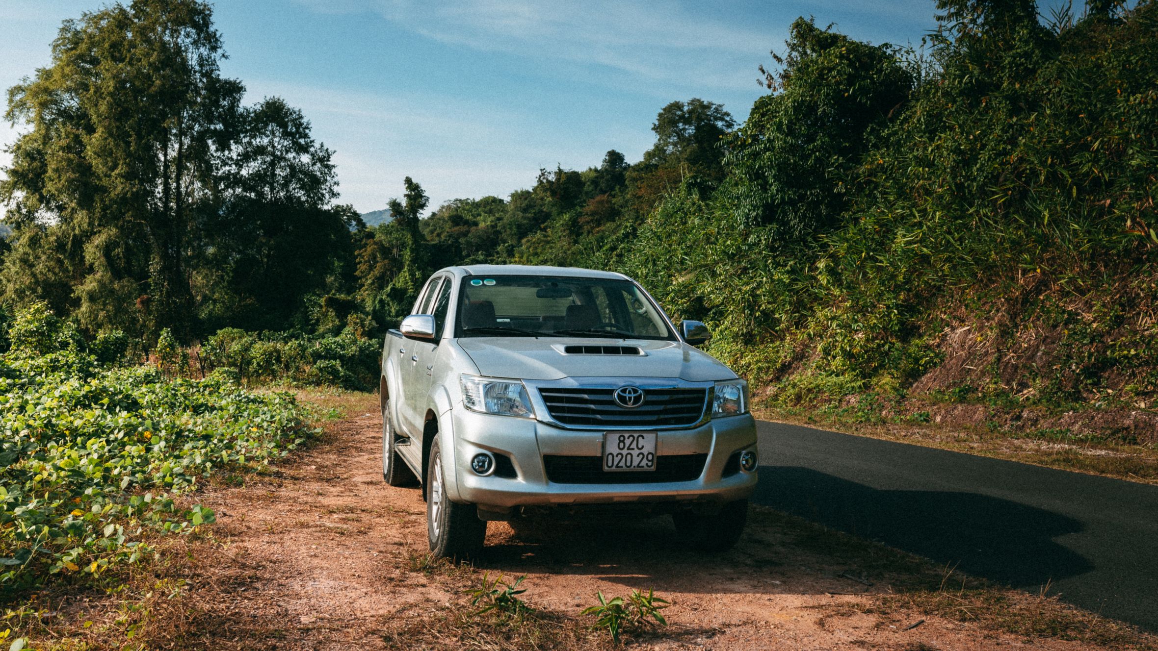 Explore Vietnam's rustic charm with an off-road vehicle amidst lush greenery in Kon Tum.