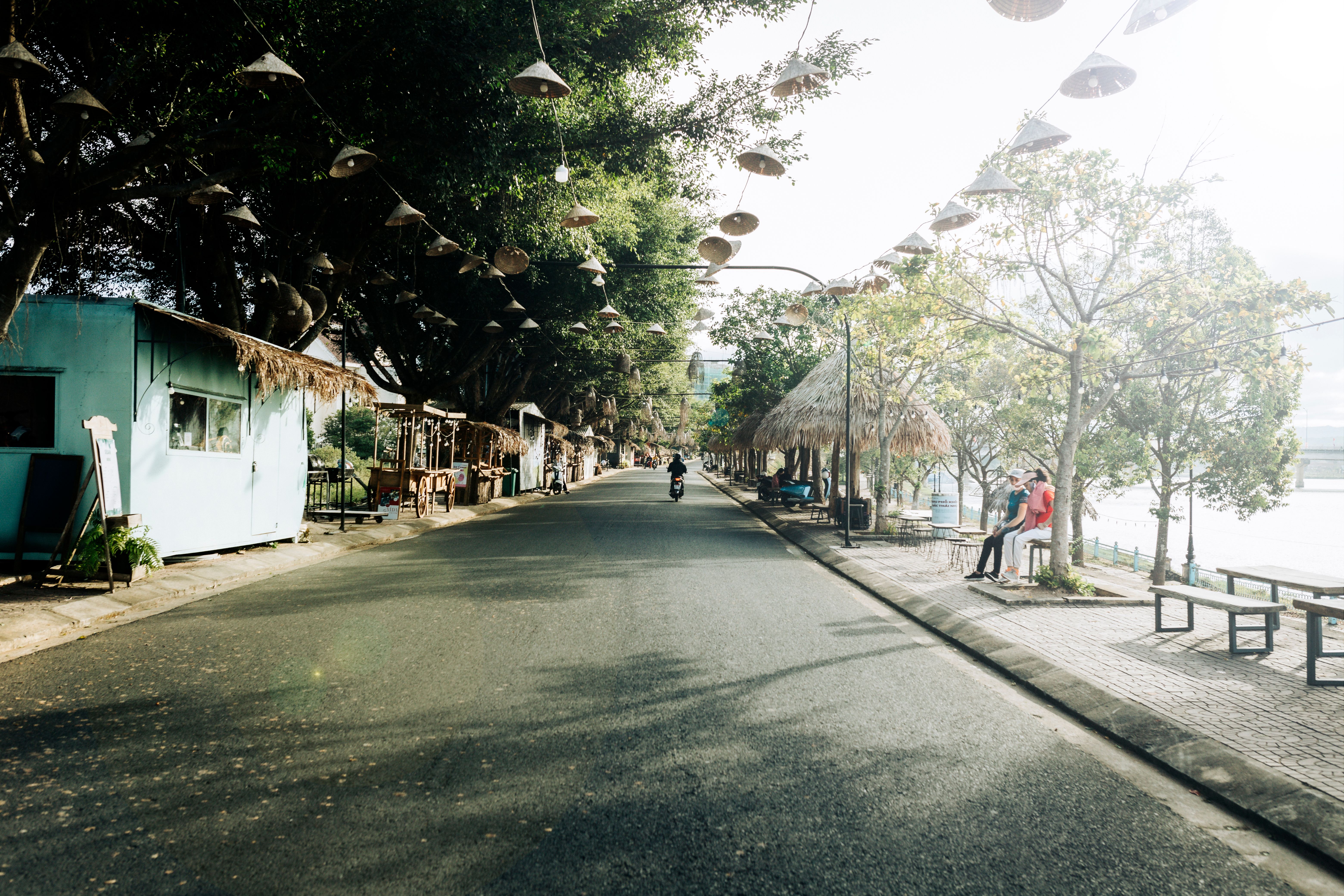 Quiet street scene in Kon Tum, Vietnam, showcasing local architecture and serene environment.