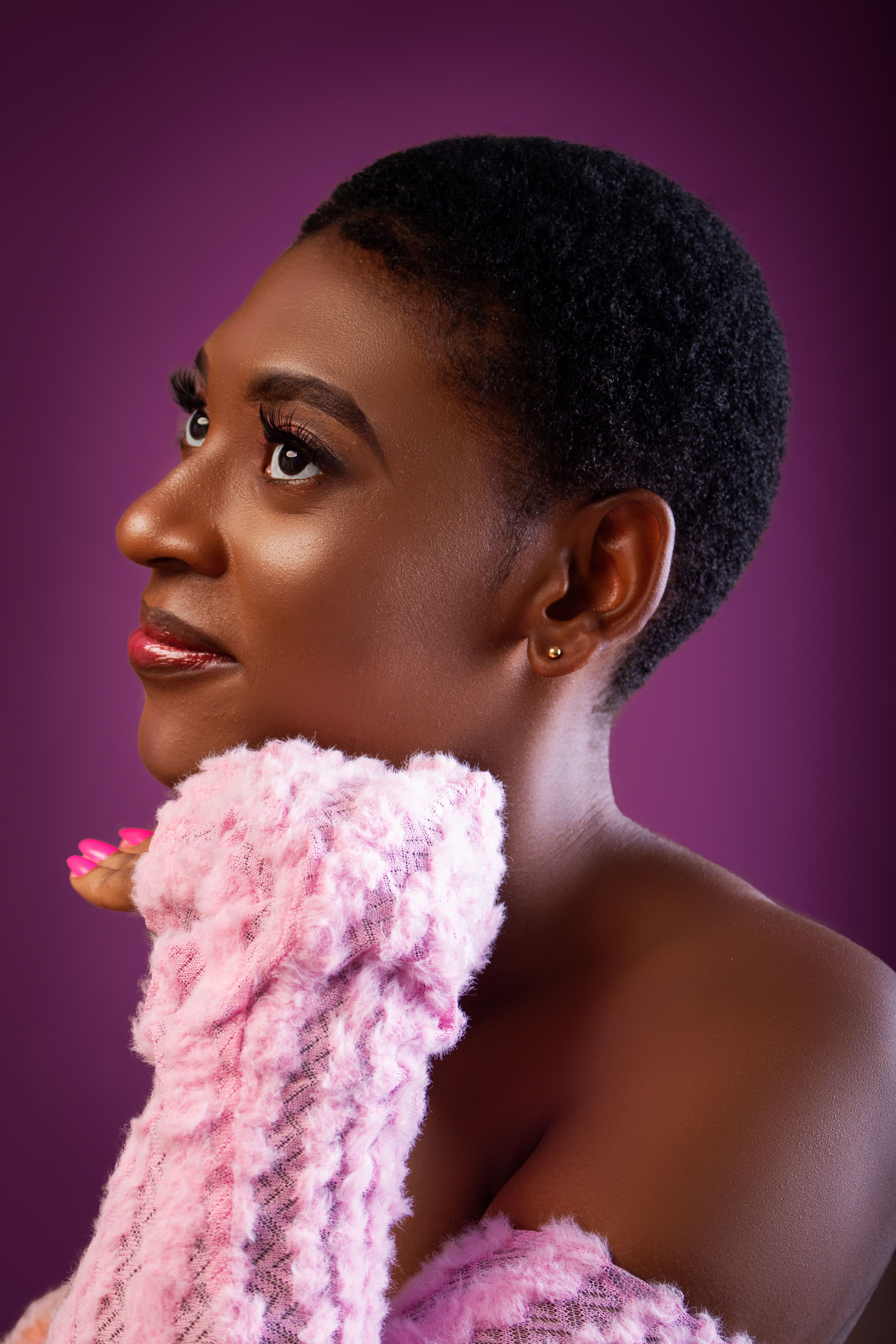 Elegant Portrait of Woman in Pink with Purple Background · Free Stock Photo