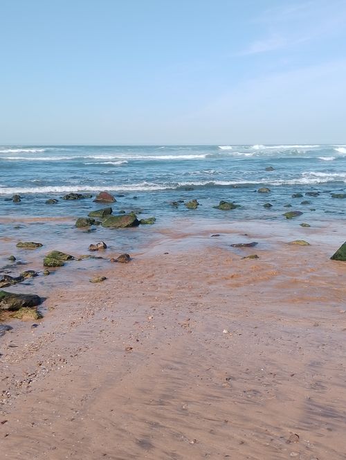 Free Peaceful beach with sea rocks and waves in Casablanca, Morocco. Stock Photo
