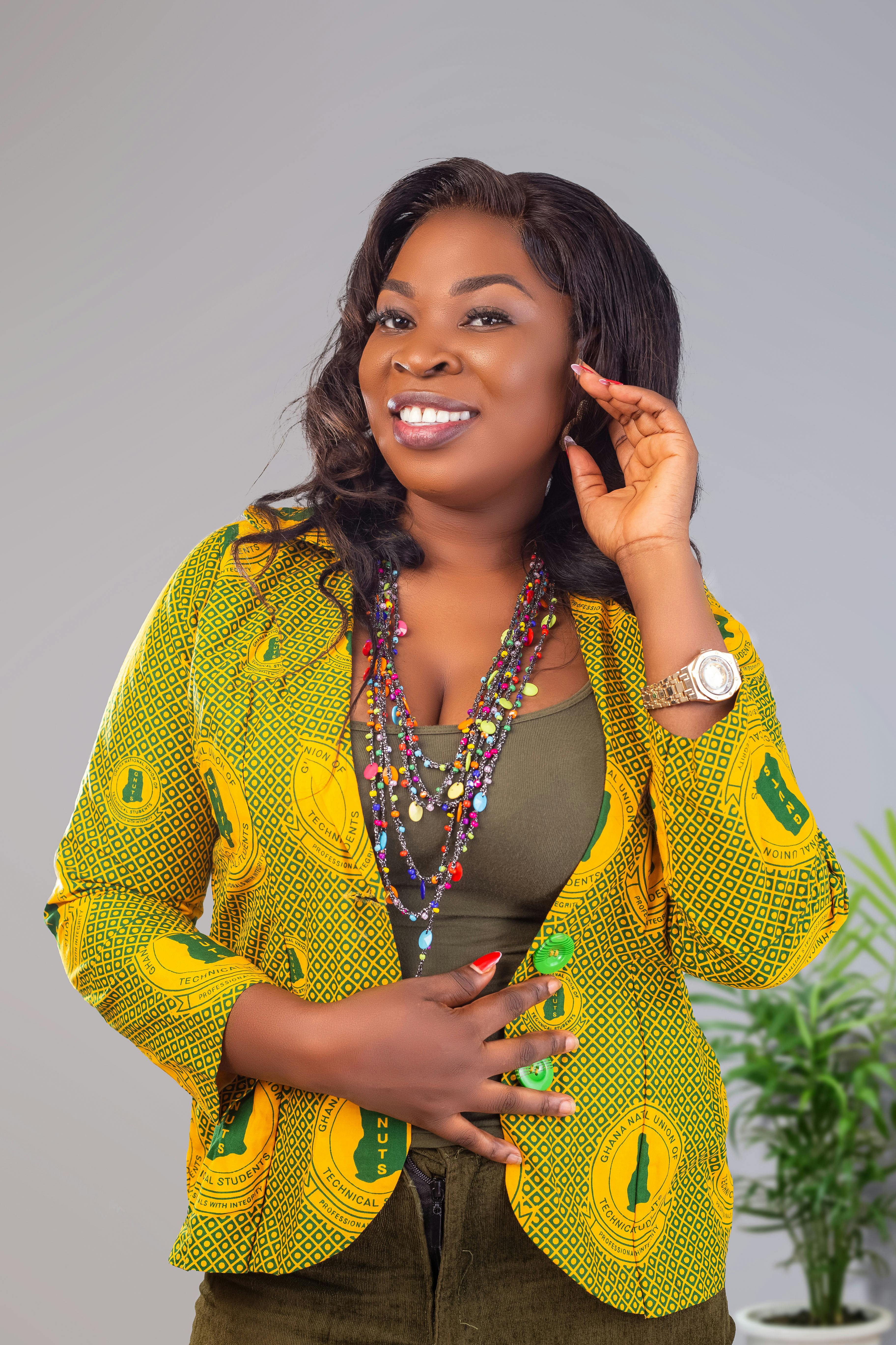 Bright portrait of a cheerful woman in traditional African yellow outfit, exuding confidence and warmth.