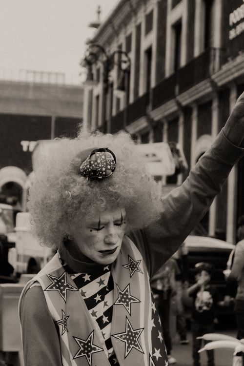 Free A clown performs on a street in Mexico, capturing the vibrant street culture. Stock Photo