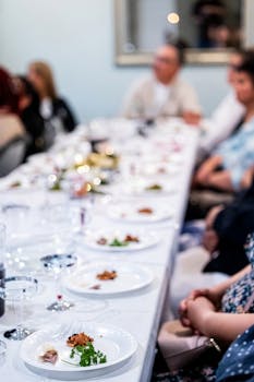 Stylish dinner party with guests enjoying gourmet dishes and elegant ambiance.