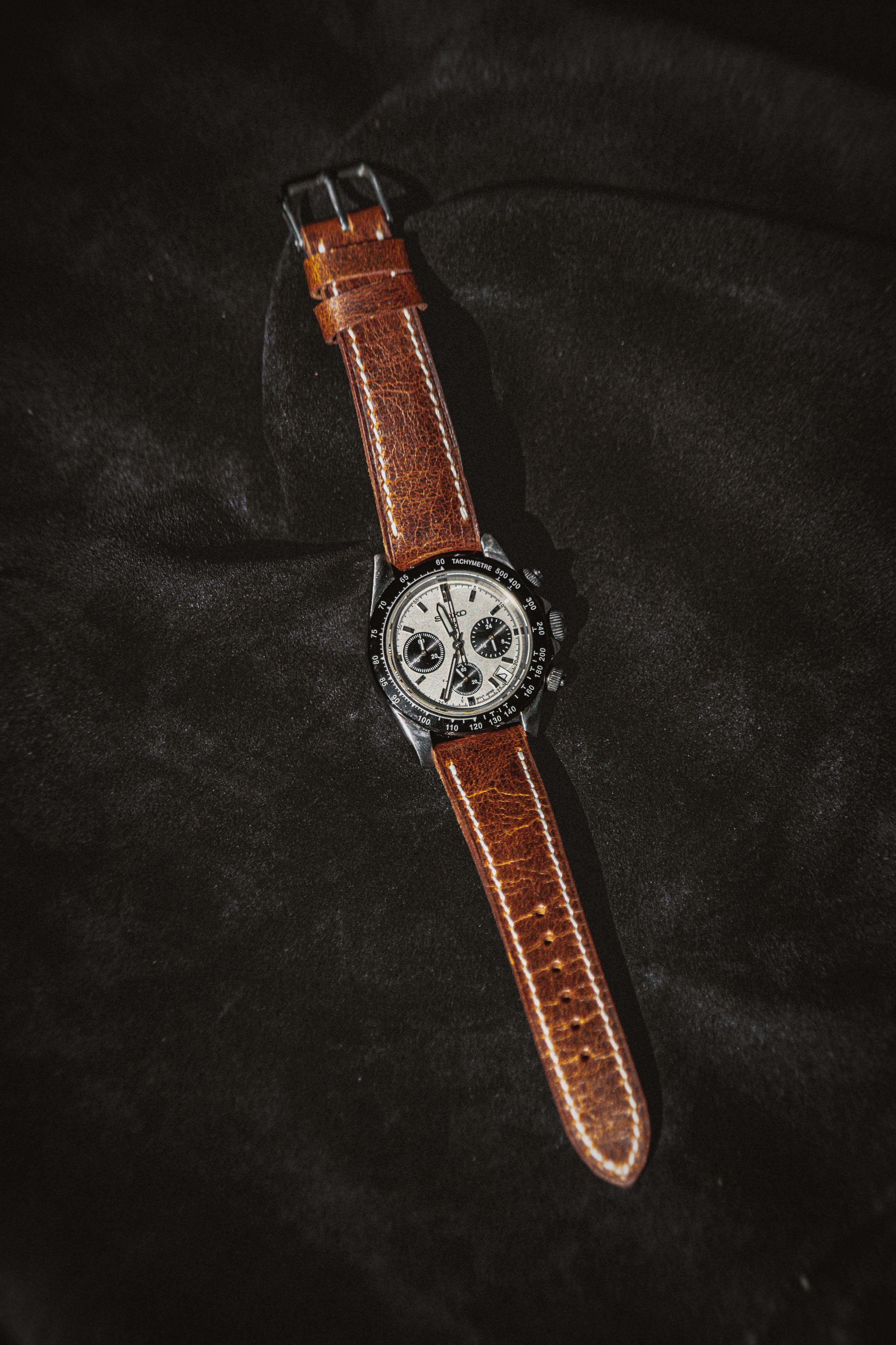 Brown leather strap watch with classic design and elegant dial.