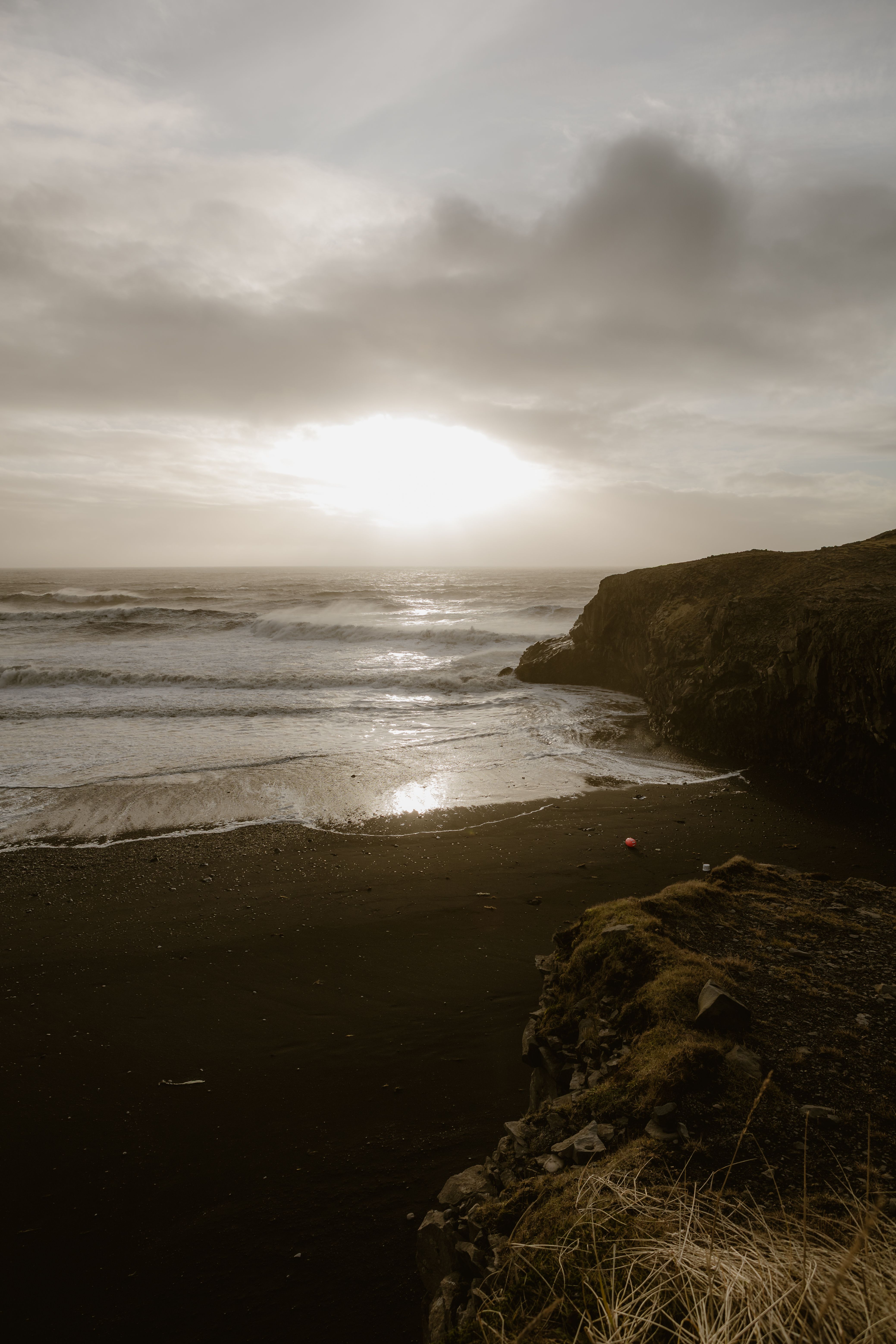 Dramatic Ocean Sunset Over Black Sand Beach · Free Stock Photo