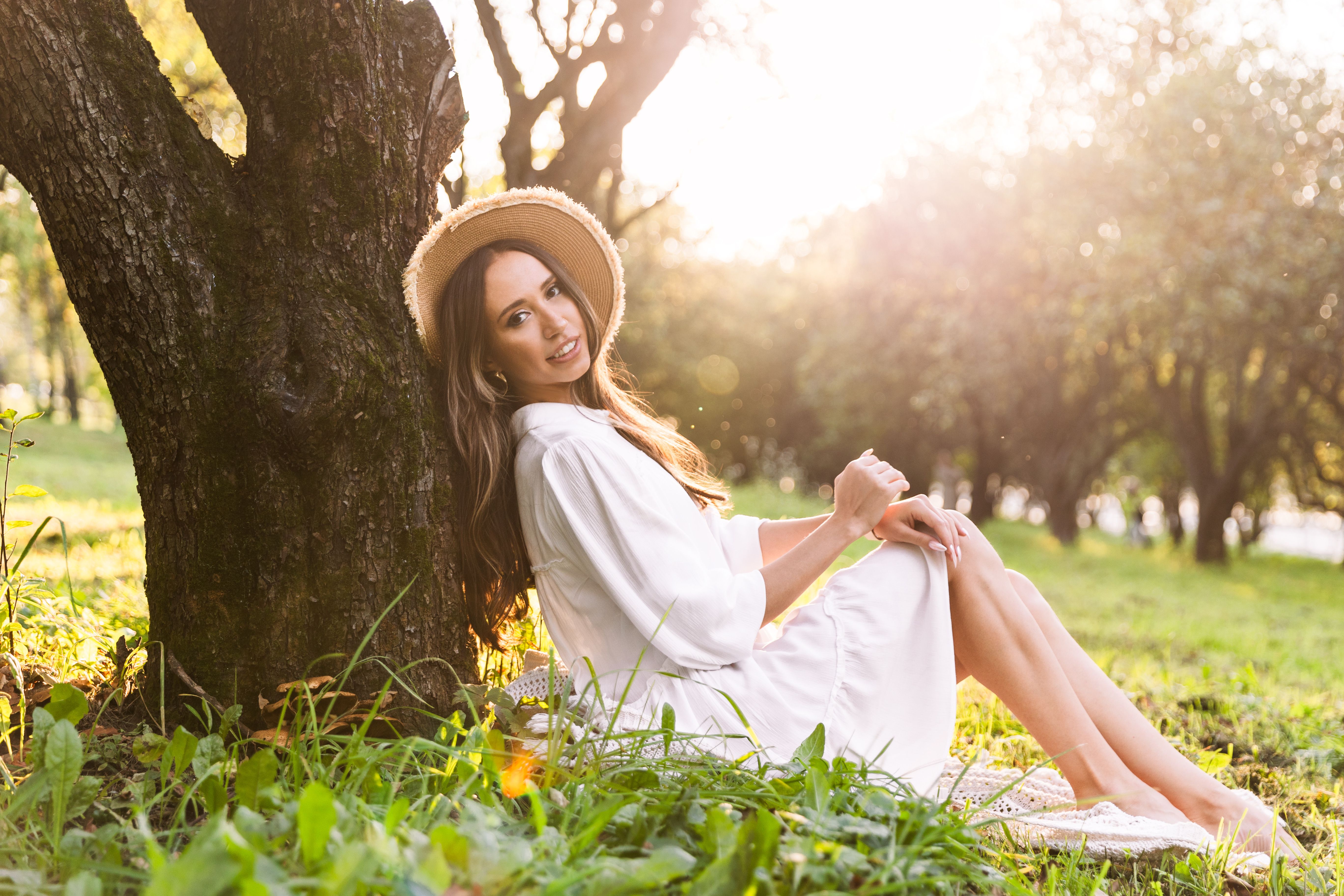 Young Woman Relaxing in a Sunny Park Scene · Free Stock Photo