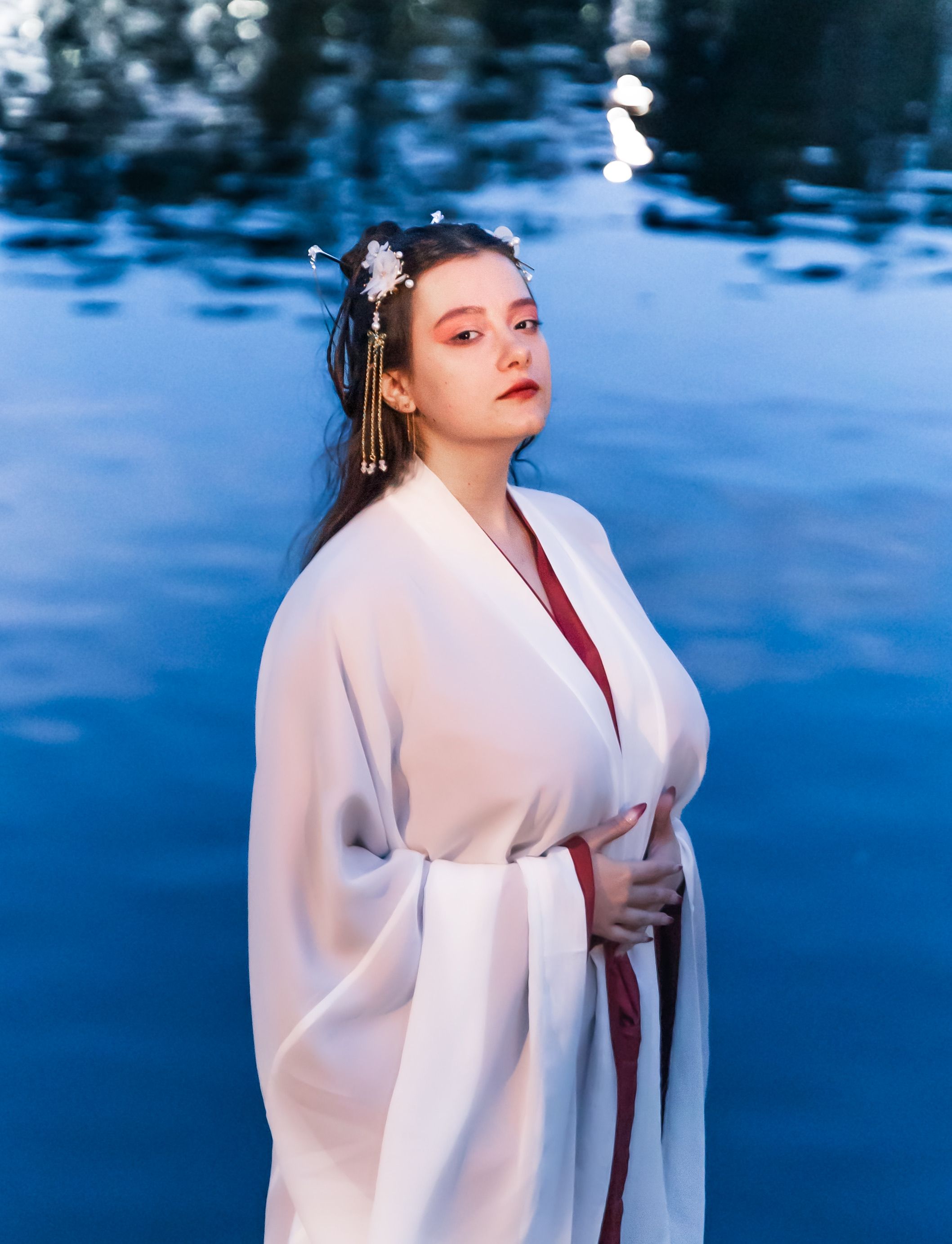 Elegant Woman in Traditional White Robe by Water · Free Stock Photo