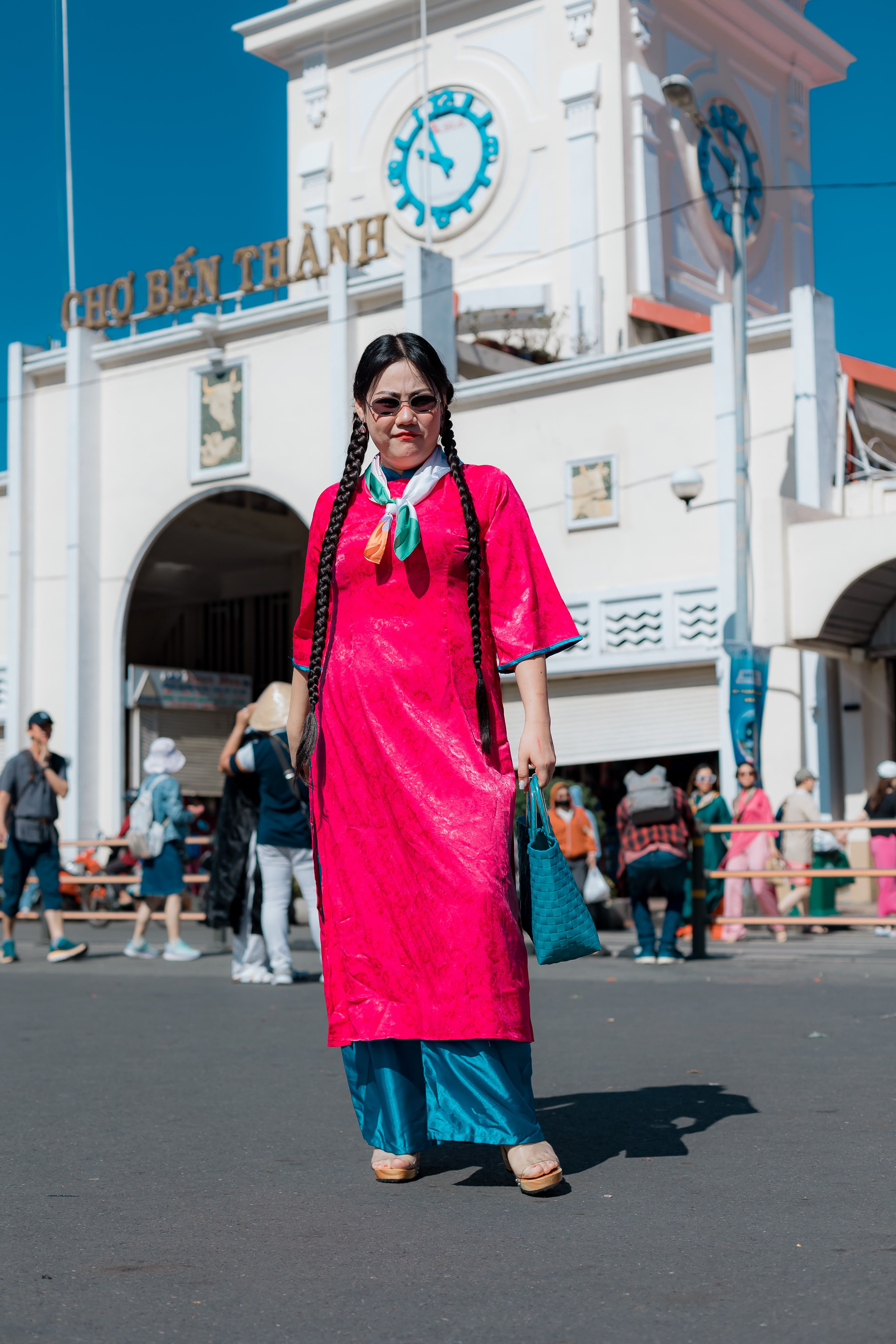 Woman wearing traditional dress at Ben Thanh Market in Ho Chi Minh City, Vietnam.
