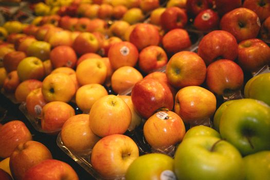 Colorful assortment of fresh apples in a grocery store, perfect for healthy lifestyle visuals.