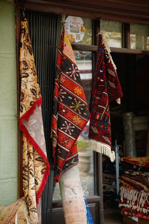 Free Vibrant traditional carpets displayed outside a shop, showcasing cultural artisan craftsmanship. Stock Photo