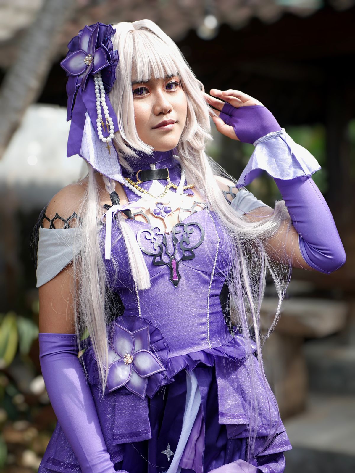 Close-up portrait of a woman in a purple anime cosplay look
