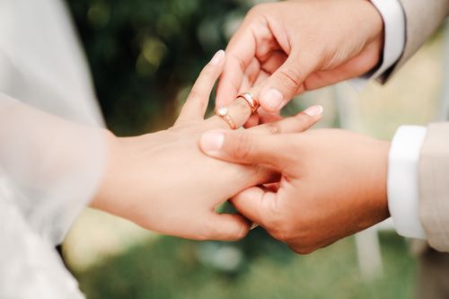 Free Close-up of a wedding ring being placed on the bride's finger, symbolizing love and commitment. Stock Photo