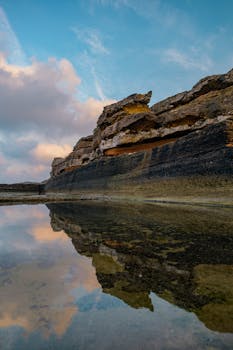 Stunning reflection of a rock formation in Kocaeli, Türkiye, with a vibrant sunset sky.