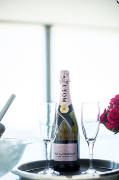 Moët & Chandon champagne with roses and glasses, perfect for a celebration setting.