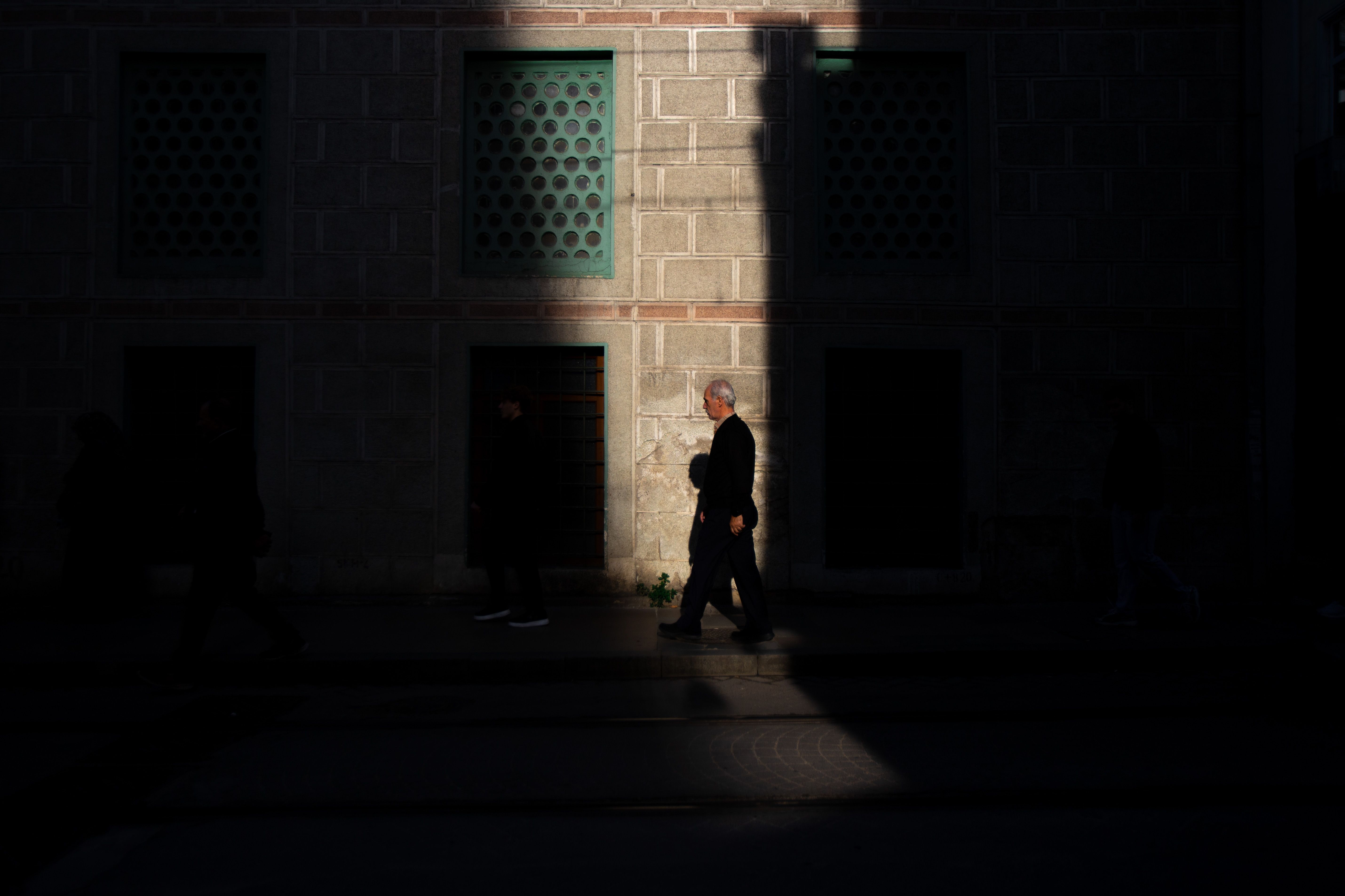 Silhouette of Man Walking in Dramatic Street Lighting · Free Stock Photo