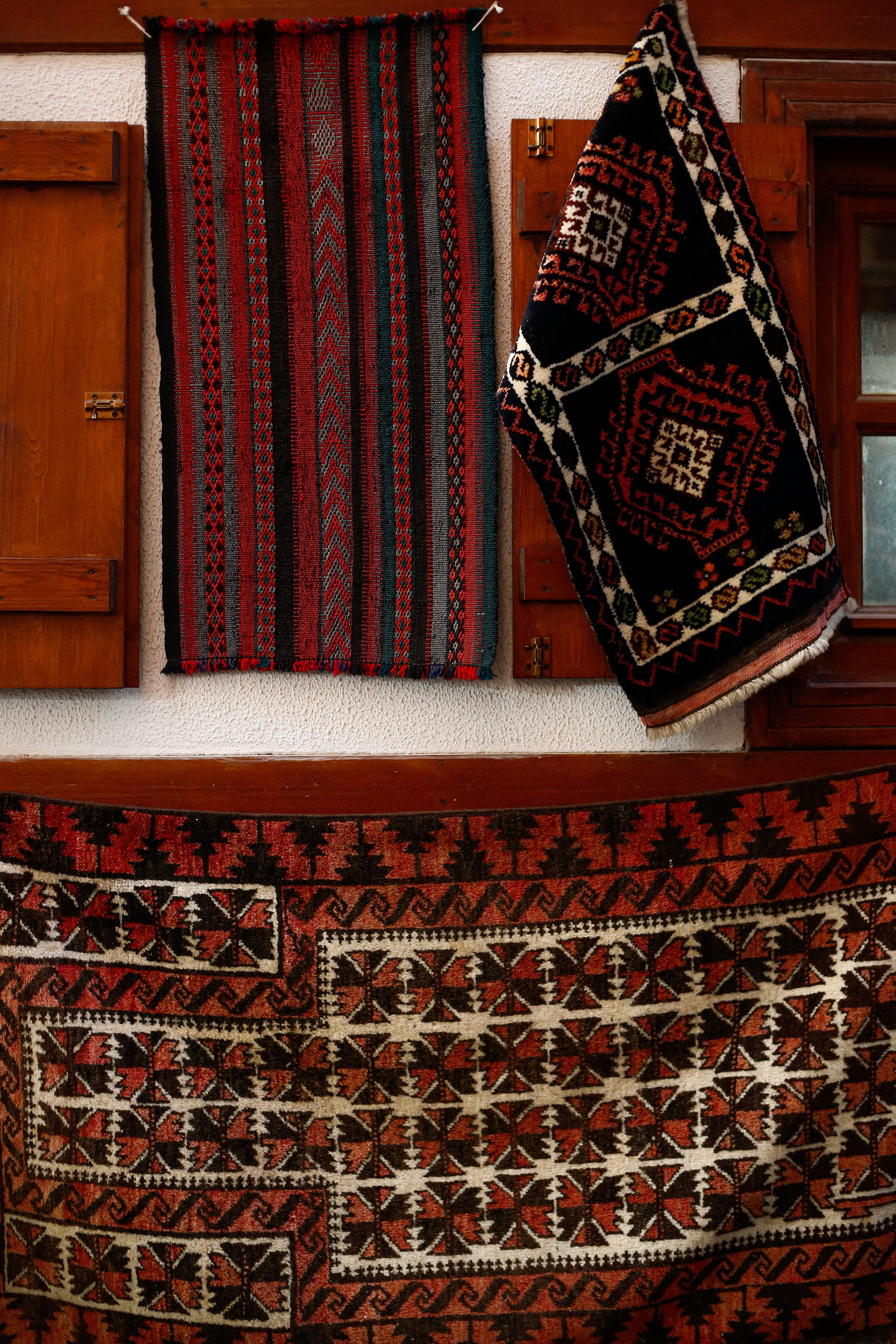 Traditional Turkish Rugs Hanging Against Wall · Free Stock Photo
