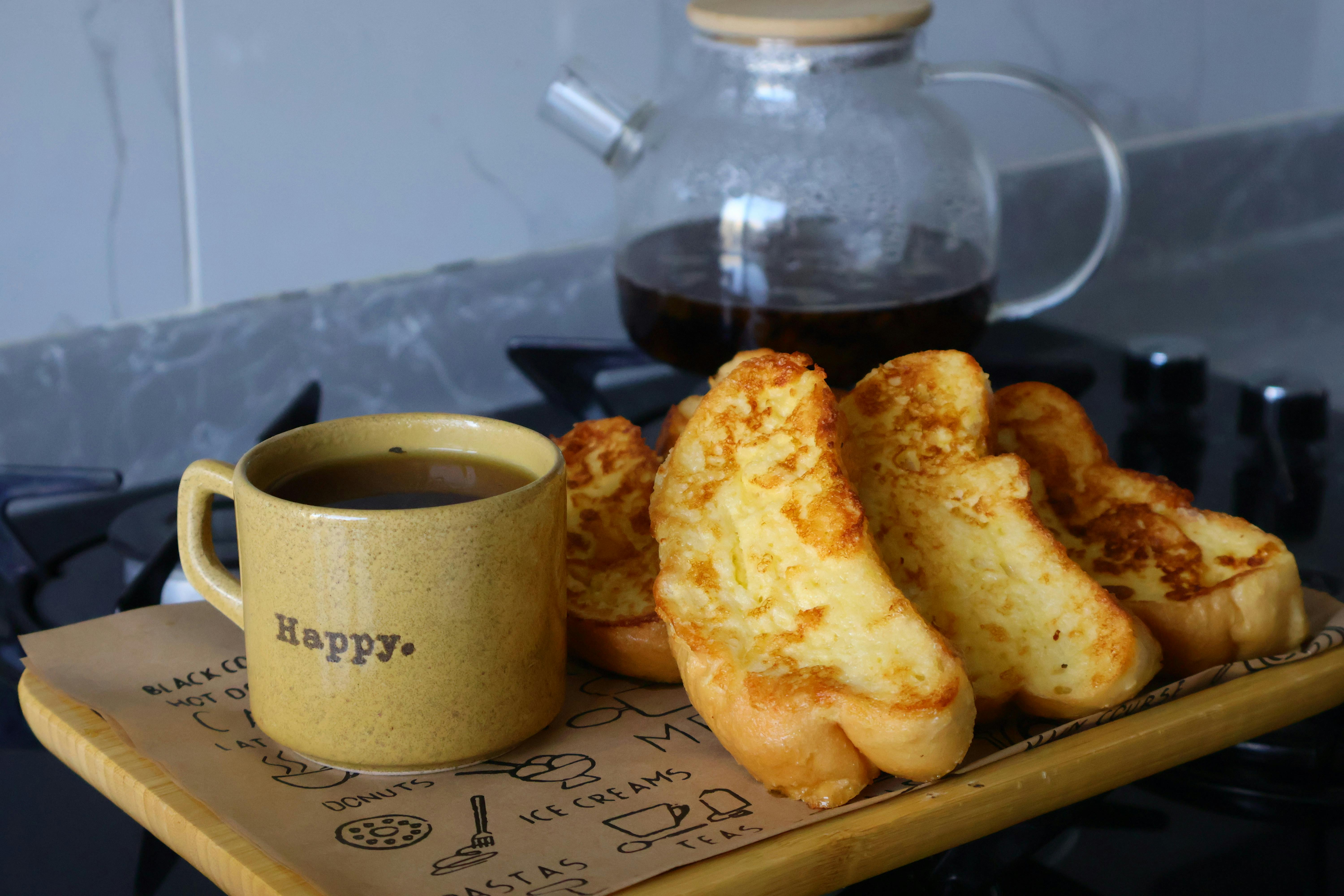 A cozy breakfast setup with French toast and coffee on a kitchen counter.