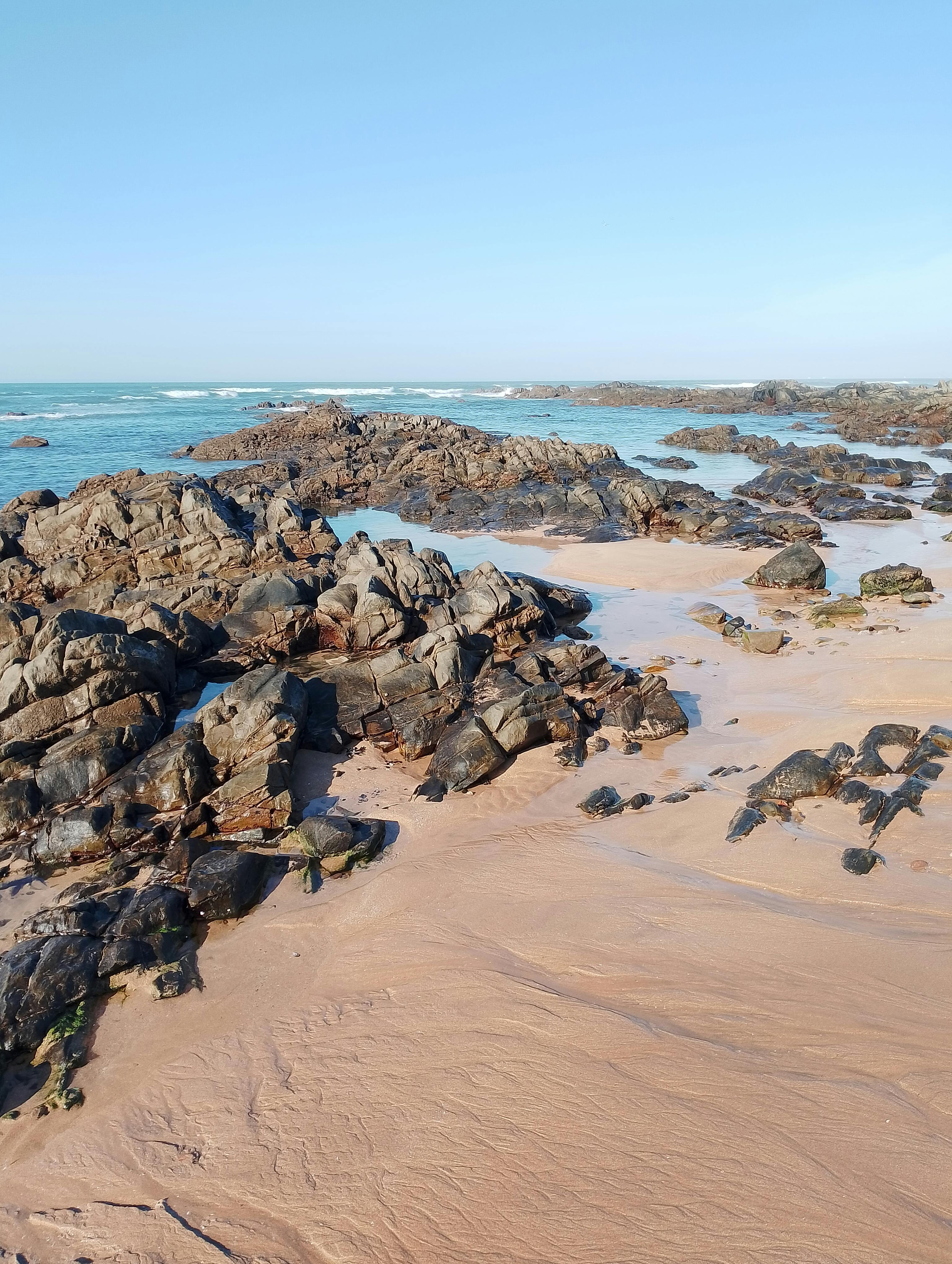 Breathtaking view of rocky coastline with crystal clear waters in Casablanca, Morocco.
