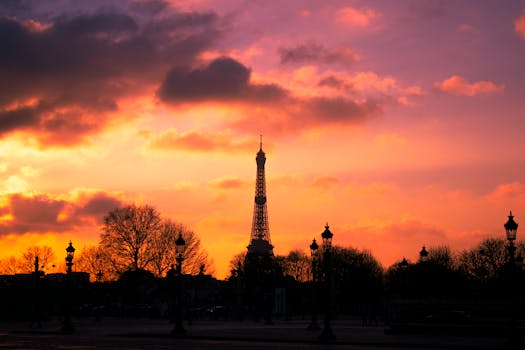 Silhouette of the Eiffel Tower with dramatic sunset colors providing a stunning backdrop.